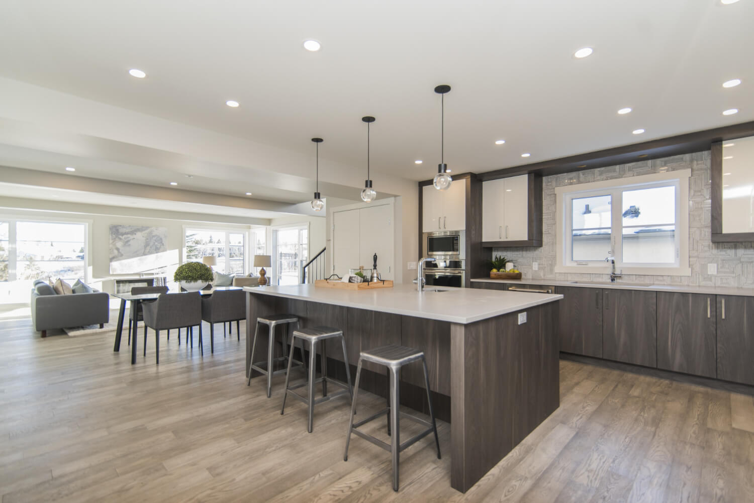 Open-plan Bellevue kitchen with an island, dark wood cabinetry, and quartz countertops