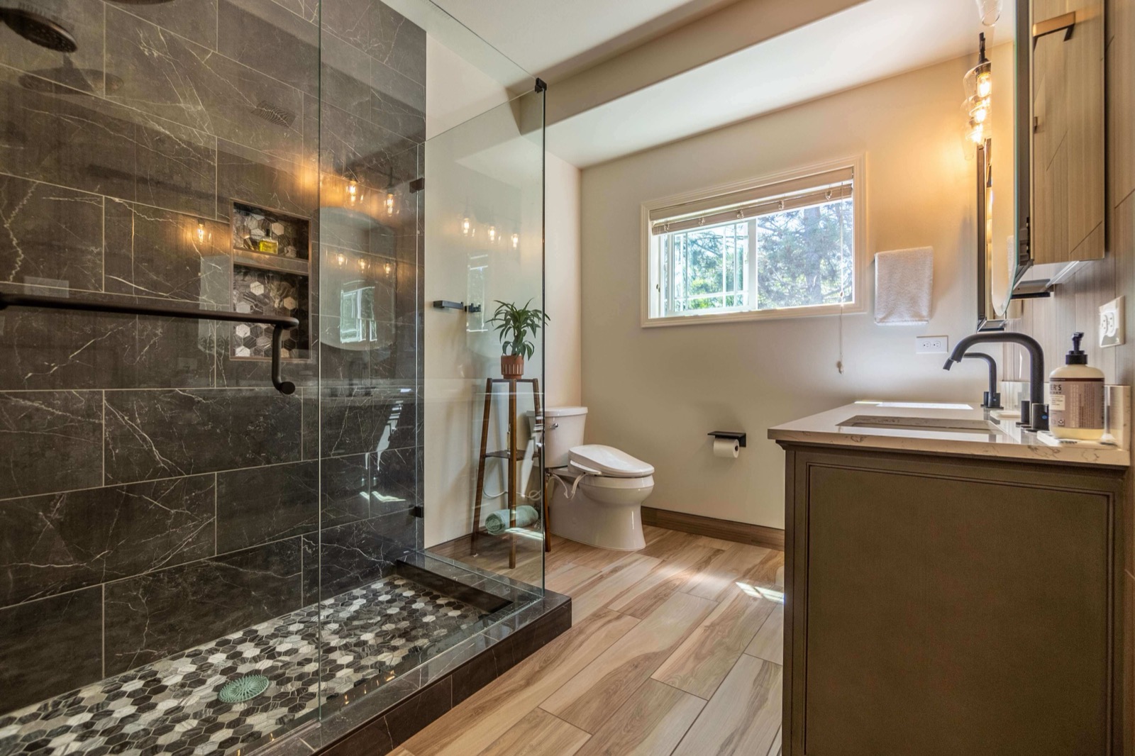 Bellevue bathroom remodel with a glass walk-in shower, marble-look tile, hexagon mosaic floor, and a quartz-top vanity