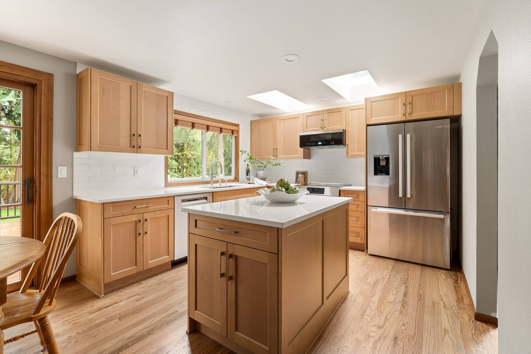 Bellevue kitchen remodel with maple shaker cabinets, a quartz island, and skylights